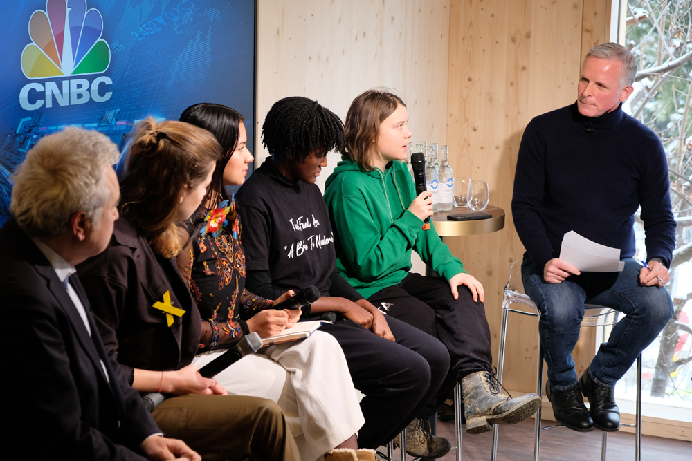 A group of people having a panel discussion with an interviewer. 